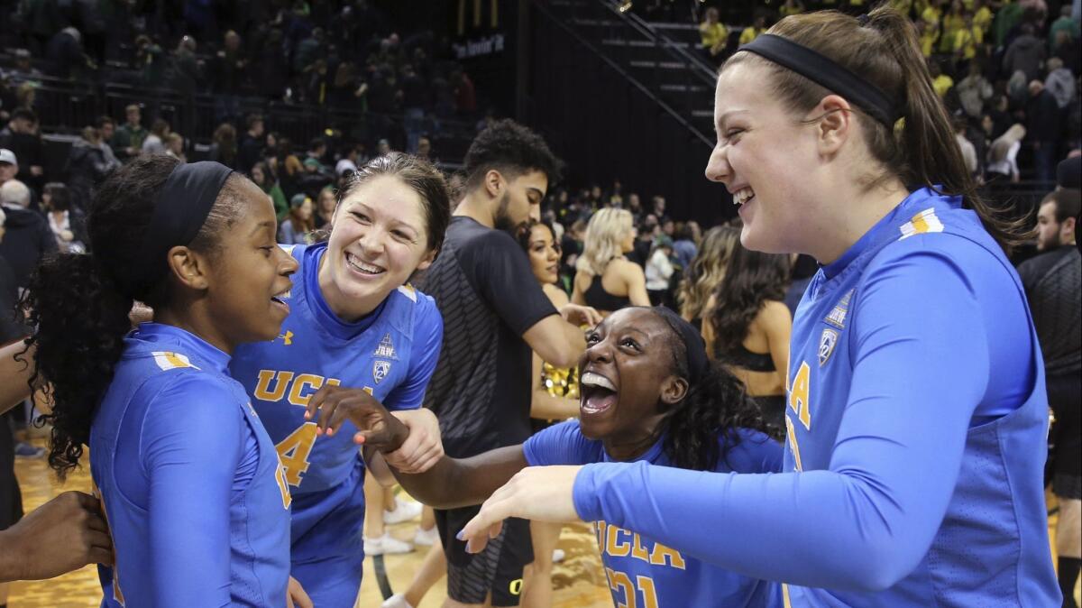 UCLA's Japreece Dean, left, Lindsey Corsaro, Michaela Onyenwere and Chrissy Baird celebrate after a 74-69 win over Oregon on Feb. 22.