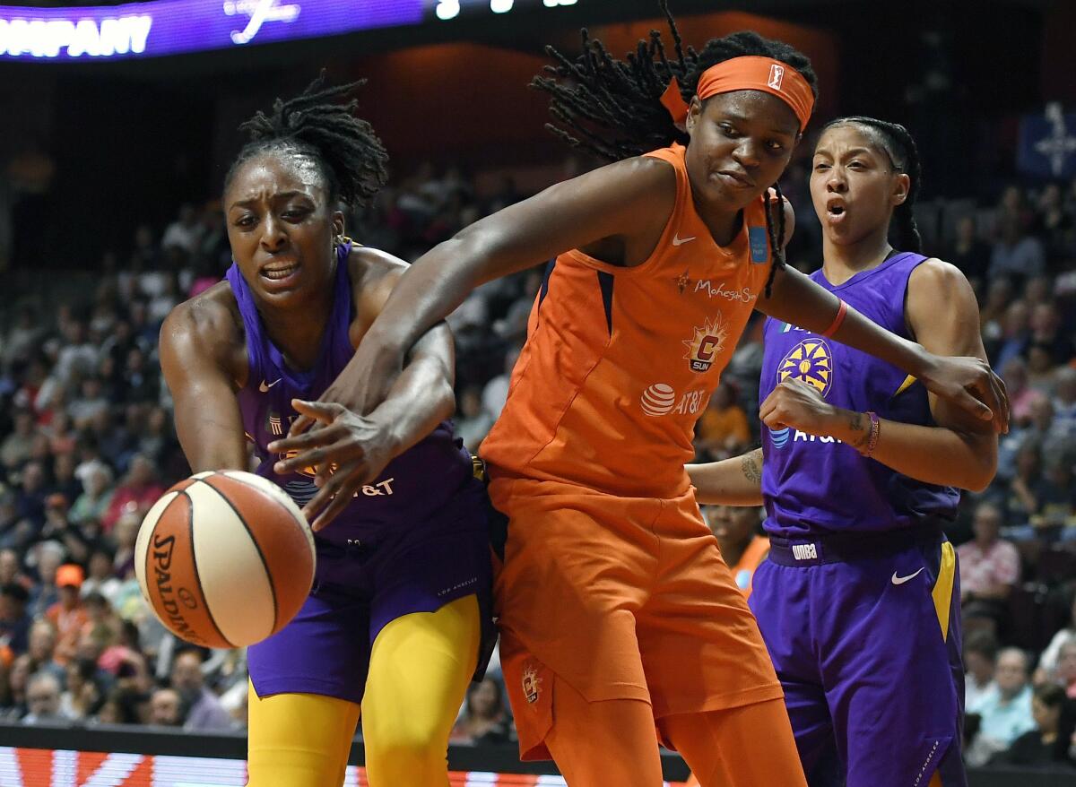 Sparks forward Nneka Ogwumike, left, and Connecticut's Jonquel Jones battle for the ball during Game 1 of the WNBA semifinals on Tuesday.