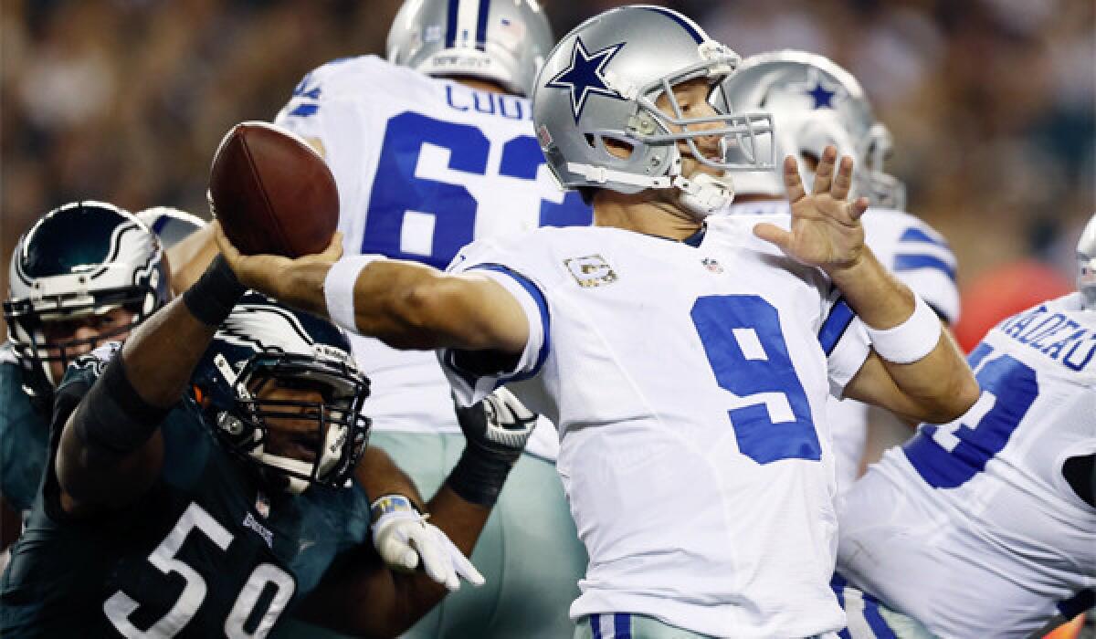 Dallas quarterback Tony Romo, shown facing pressure from Philadelphia's DeMeco Ryans, has thrown for 26 touchdowns with 16 interceptions this season.