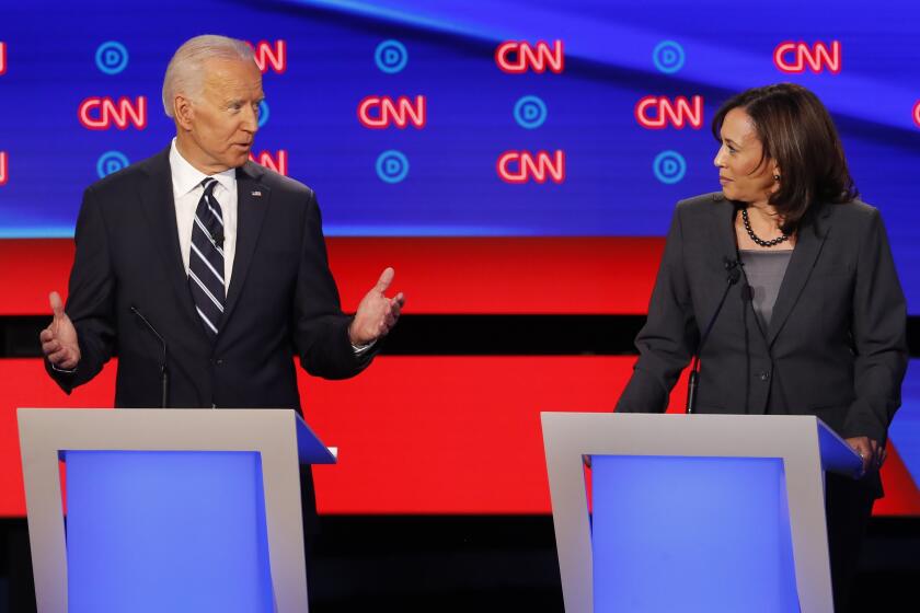 FILE - In this July 31, 2019 file photo, former Vice President Joe Biden speaks as Sen. Kamala Harris, D-Calif., listens during the second of two Democratic presidential primary debates hosted by CNN in the Fox Theatre in Detroit. As presumptive Democratic presidential nominee Joe Biden begins the process of choosing a running mate amid the coronavirus crisis, managing the pandemic has become its own version of an audition. For potential picks, lobbying for the job means breaking into the national conversation, positioning themselves as leaders and executing at their day job. (AP Photo/Paul Sancya)