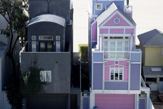 SANTA MONICA, CA - FEBRUARY 15: Two houses: the Barbie House, pink and purple, right, and the all-black house right next to it, left, located at 1341 Palisades Beach Road and 1343 Palisades Beach Road, respectively, on Wednesday, Feb. 15, 2023 in Santa Monica, CA. They've gone viral on social media due to their stark contrast in style. (Brian van der Brug / Los Angeles Times)