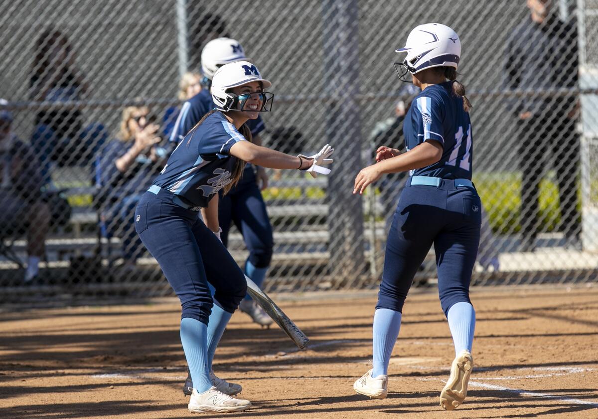 Marina's Rylee Gonzalez, left, congratulates Coral Piramo after she drives in a run on a fielder's choice in the second.