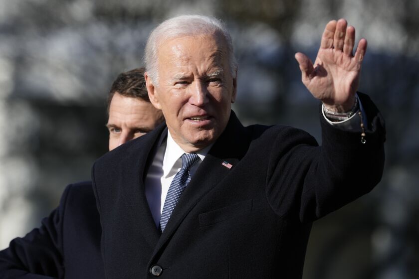 President Joe Biden and French President Emmanuel Macron stand on the stage during a State Arrival Ceremony on the South Lawn of the White House in Washington, Thursday, Dec. 1, 2022. (AP Photo/Alex Brandon)