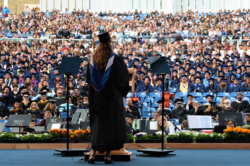 OCC Prof. Kelli Elliot, an Orange County Teacher of the Year, speaks Friday during the school's 75th commencement ceremony.