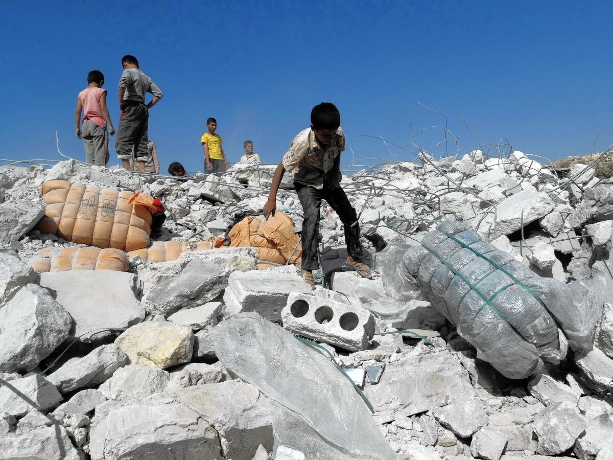Syrians inspect the rubble of a home reportedly hit by a U.S.-led coalition airstrike in Kafar Daryan. As many as two dozen civilian deaths in airstrikes were reported by Syrians.