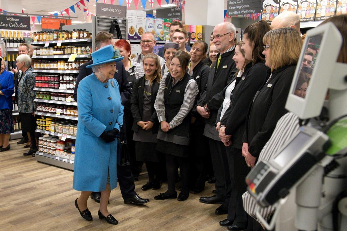 Queen Elizabeth II greets the Waitrose staff.