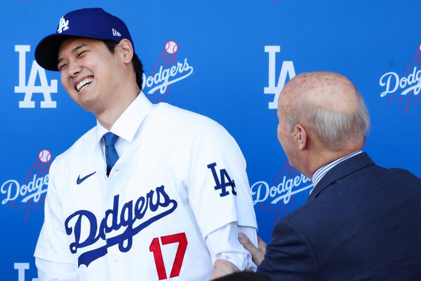 Shohei Ohtani, left, has a laugh with Doders president Stan Kasten.