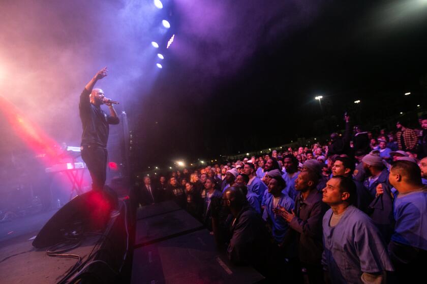 Norco, CA., December 6, 2019: Residents incarcerated at the California Rehabilitation Center enjoys being stage side at Common’s performance on Friday, December 6, 2019. Common, a well-known actor, rapper and activist, performs a concert for residents incarcerated at the California Rehabilitation Center on Friday, December 6, 2019. Represent Justice Campaign in conjunction with Common’s Imagine Justice Initiative and Anti-Recidivism Coalition came together to organize this event. (Jason Armond / Los Angeles Times)