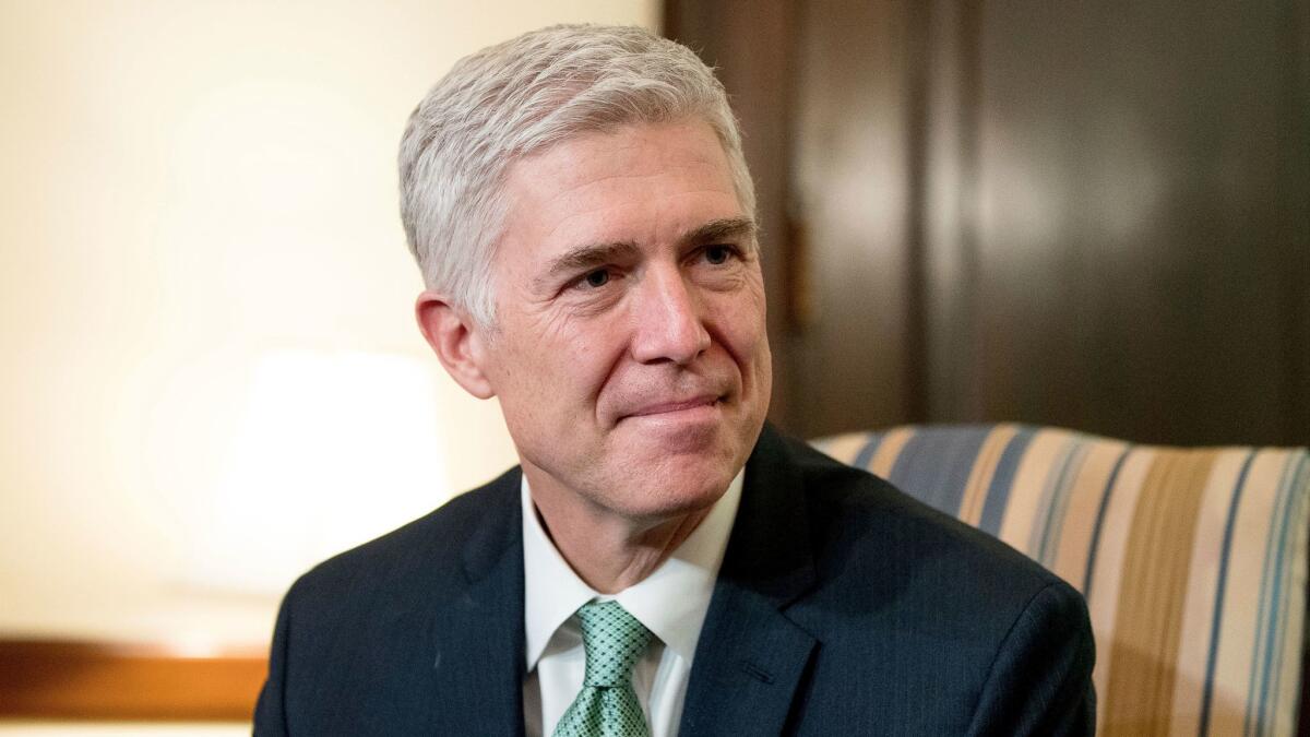 Supreme Court Justice nominee Judge Neil Gorsuch meets with Sen. Chris Coons, D-Del. on Capitol Hill in Washington on Feb. 14.