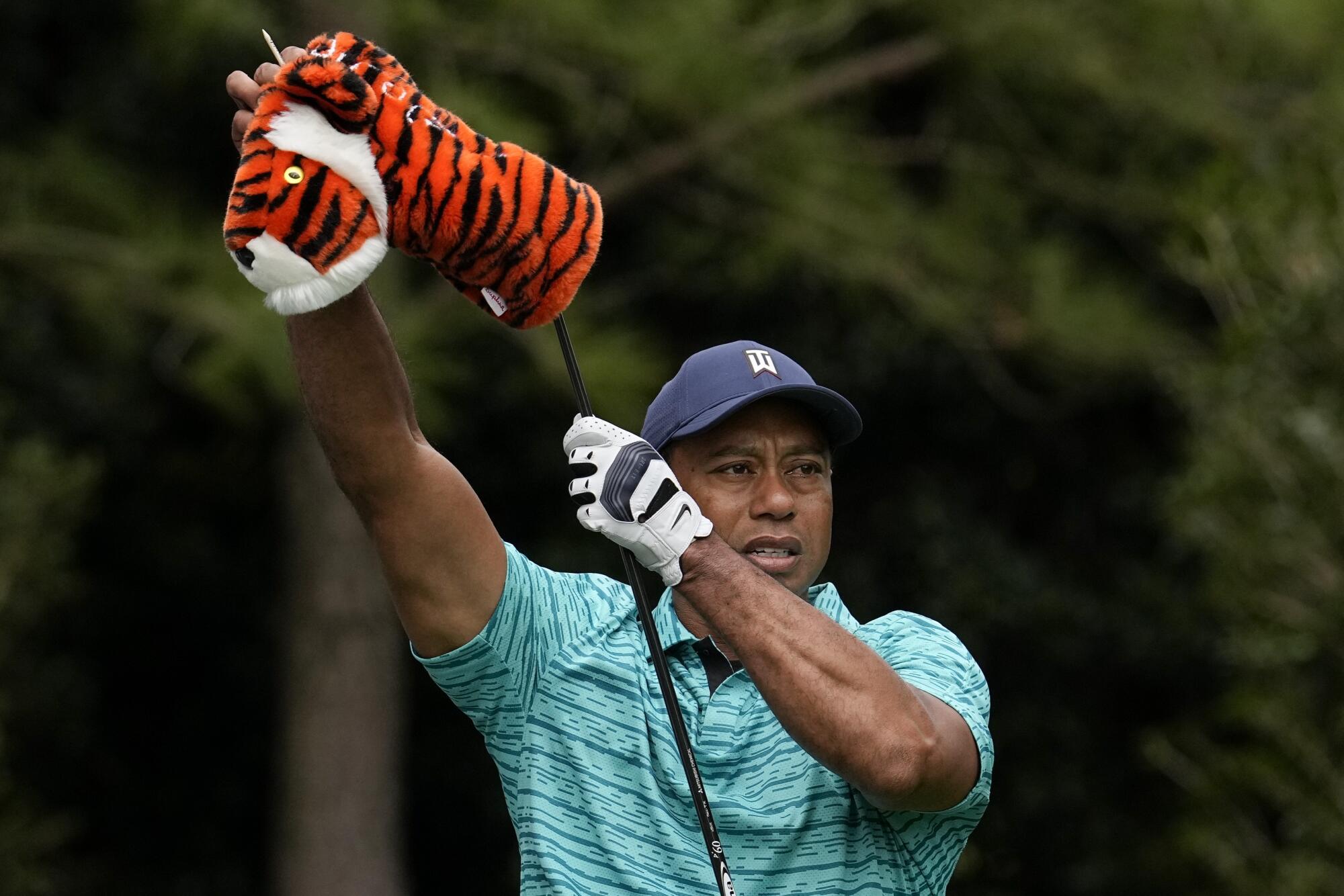 Tiger Woods takes the head cover off of his driver on the 11th tee during the second round.