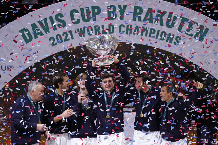 The Russian Tennis Federation team celebrate with the trophy after winning the Davis Cup tennis final at the Madrid Arena in Madrid, Spain, Sunday, Dec. 5, 2021. (AP Photo/Manu Fernandez)