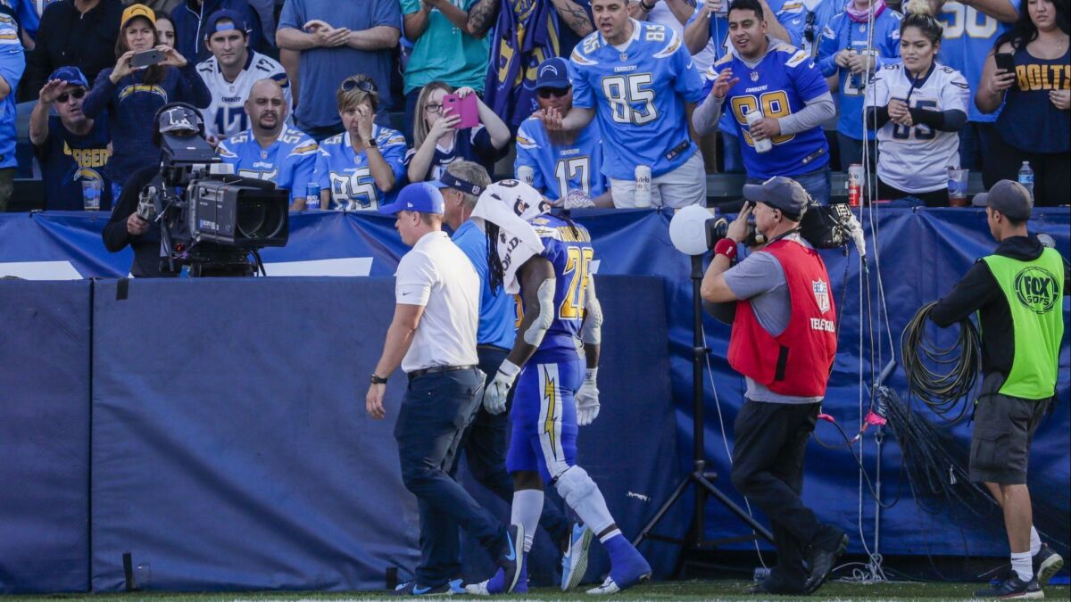 Chargers running back Melvin Gordon leaves the field after suffering a knee injury against Arizona on Sunday at StubHub Center.