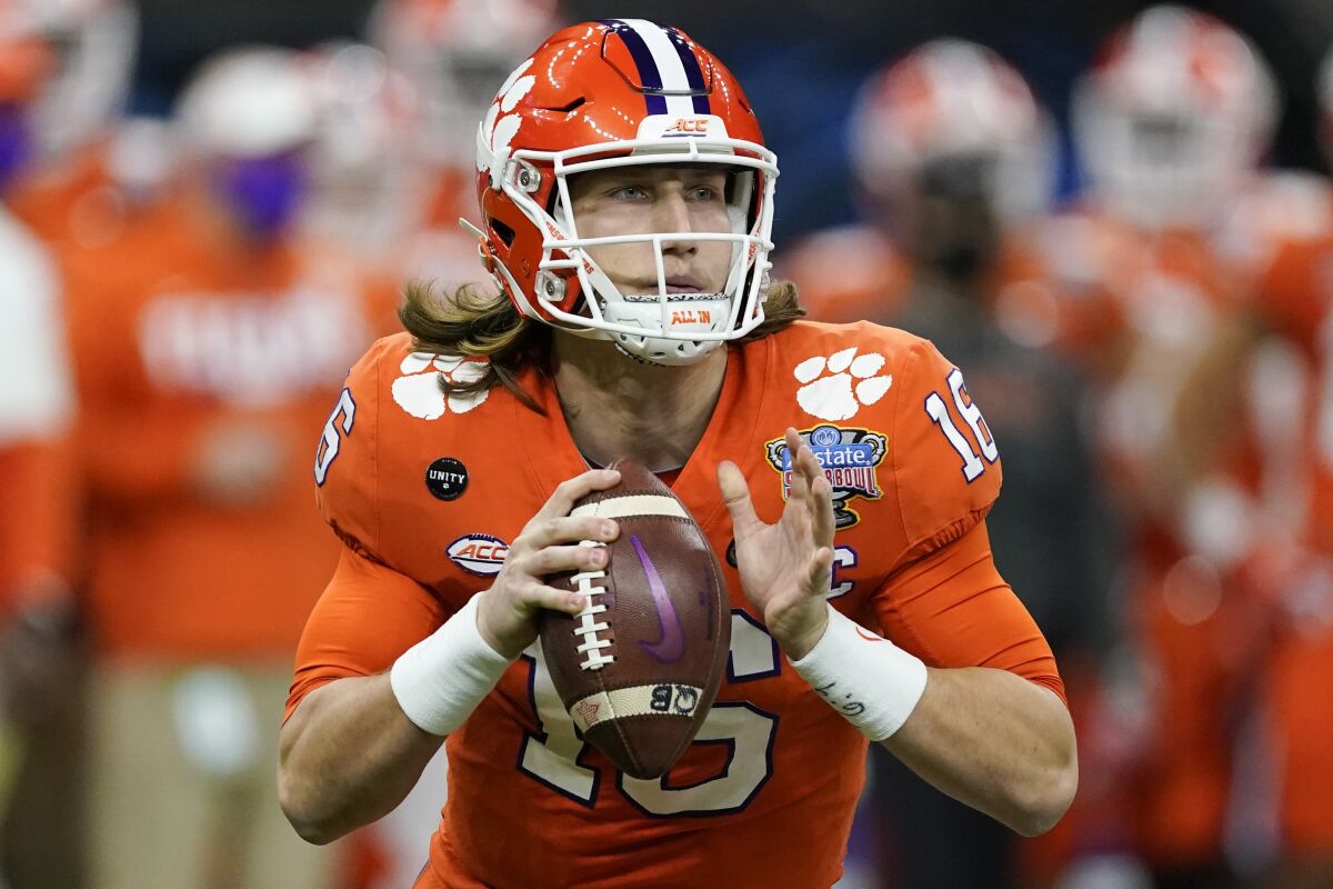 Clemson quarterback Trevor Lawrence looks to pass during a game.