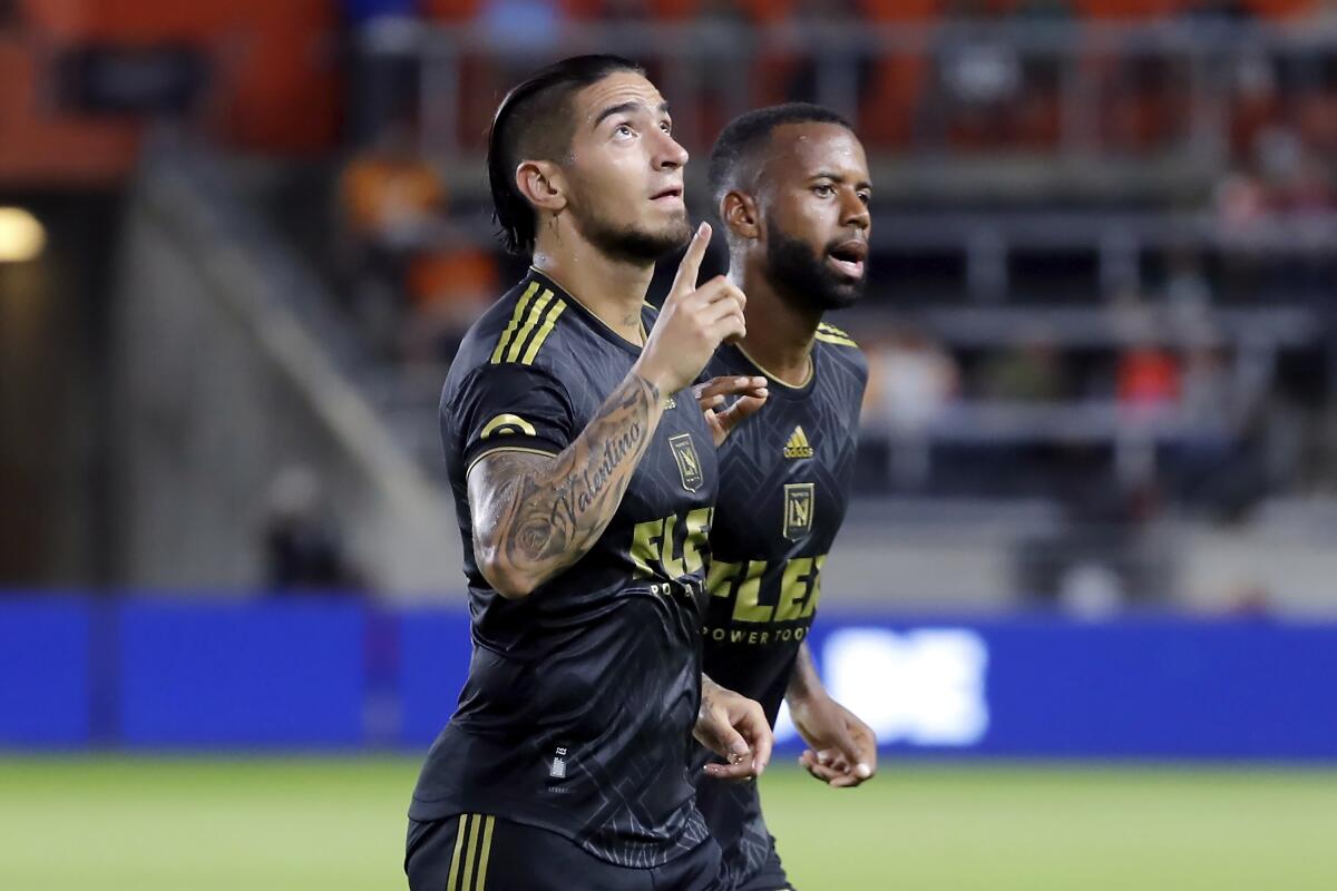 LAFC forward Cristian Arango points up while running next to midfielder Kellyn Acosta 