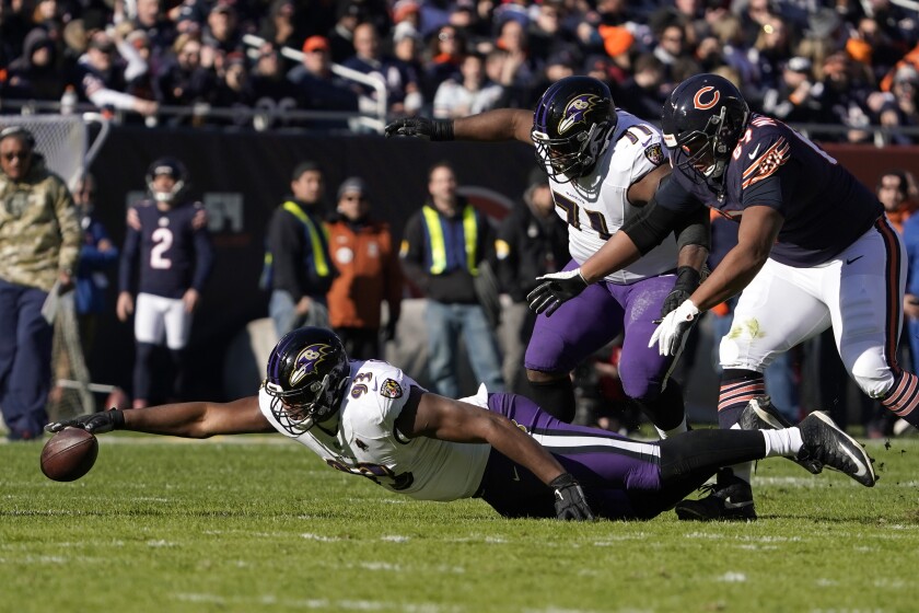 Baltimore Ravens defensive end Calais Campbell (93) reaches out and recovers a fumble during the first half of an NFL football game against the Chicago Bears Sunday, Nov. 21, 2021, in Chicago. (AP Photo/David Banks)
