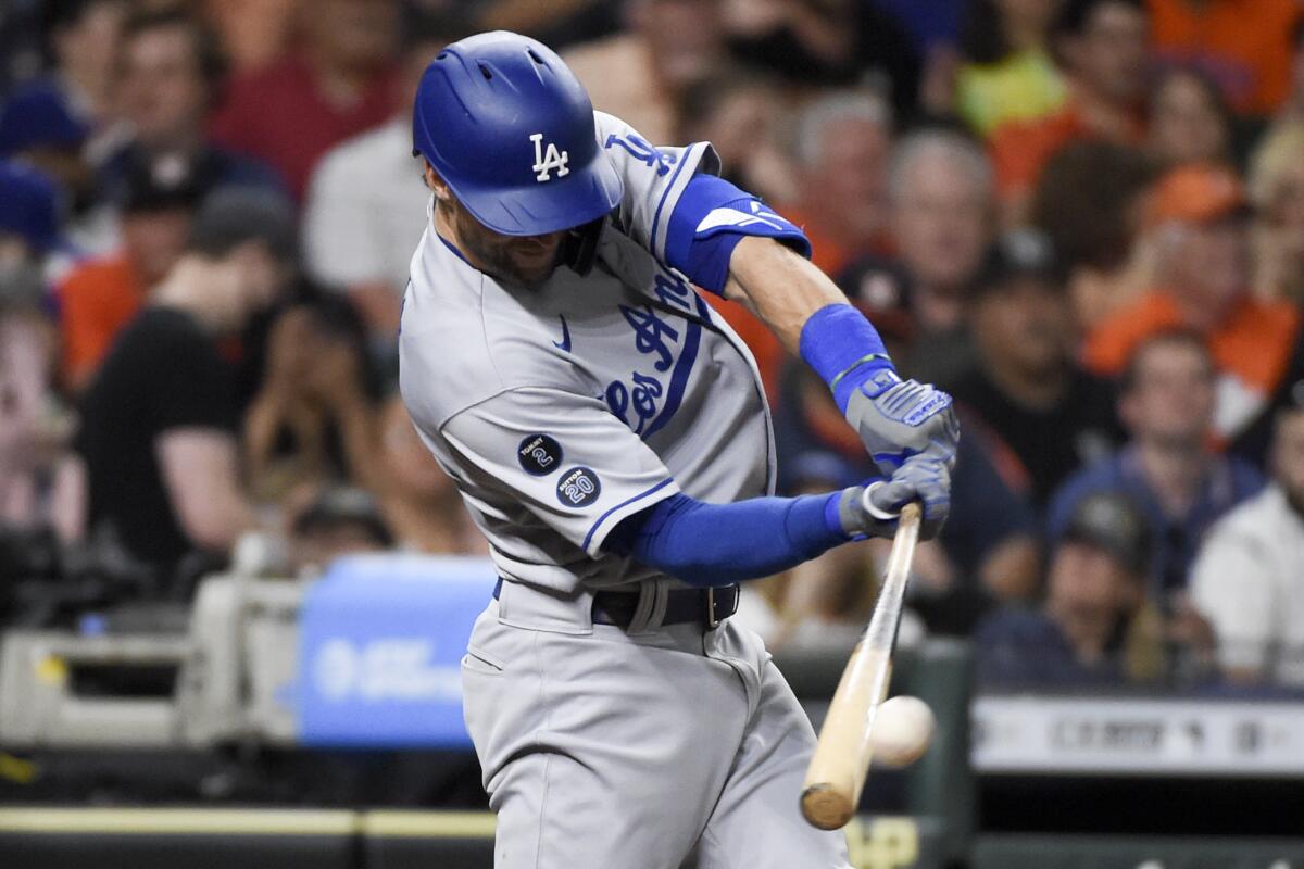 Dodgers center fielder Chris Taylor hits a two-run single during the sixth inning against the Houston Astros.