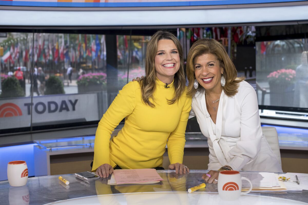 FILE - "Today" show co-anchors Savannah Guthrie, left, and Hoda Kotb pose on set at NBC Studios inNew York on June 27, 2018. Guthrie, Kotb and other NBC News hosts will read a murder mystery, "Murder at Studio One,' later this month at a New York theater. It will be recorded for a later podcast by Audible, Inc. (Photo by Charles Sykes/Invision/AP, File)