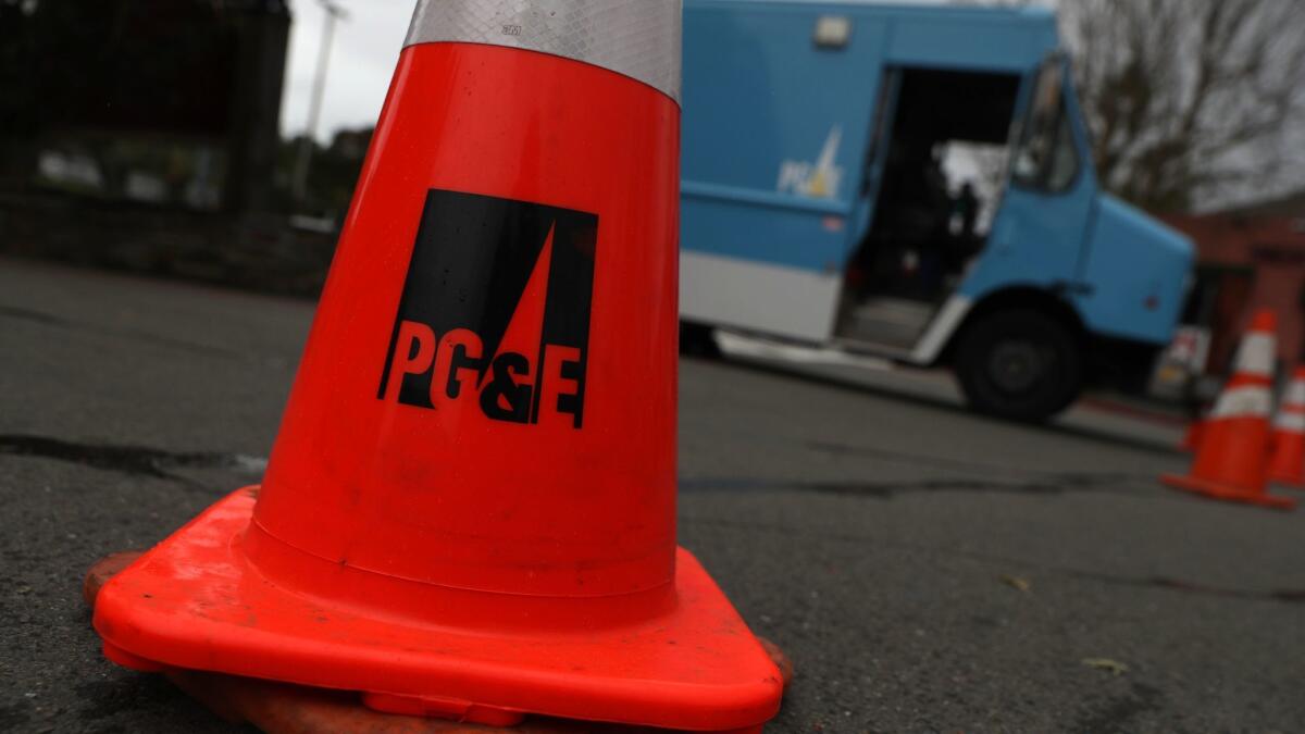 A traffic cone sits next to a Pacific Gas & Electric Co. truck in Fairfax, Calif.