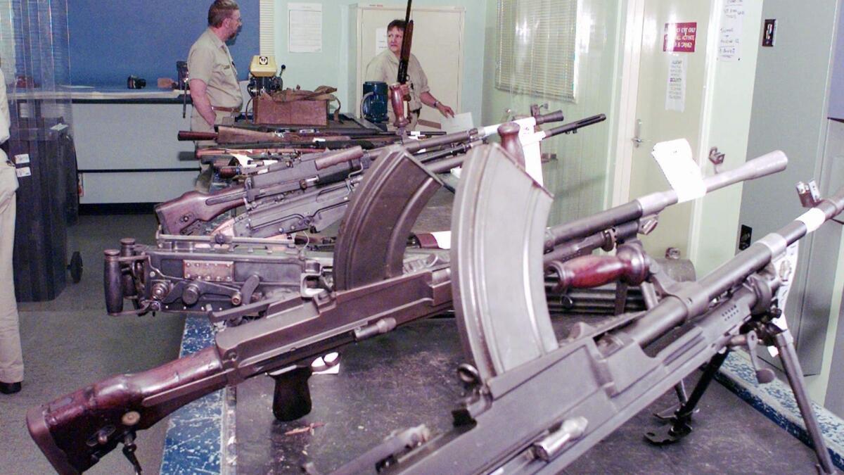 Police department workers in Sydney sort and catalog weapons handed in for refunds as part of the Australian government's money-for-guns plan in 1997. A new study raises doubt about whether the policy actually reduced gun deaths in the country.