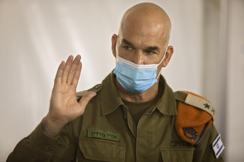 Maj. Gen. Ori Gordin, head of the Israeli army’s Home Front Command, gestures as he speaks at its headquarters, in Ramle, Central Israel, Tuesday, Aug. 25, 2020. Gordin is overseeing the military’s coronavirus “task force,” formed in August to bring one of the developed world’s worst outbreaks under control. Its main responsibility is taking the lead in contact tracing and breaking chains of infection. (AP Photo/Sebastian Scheiner)