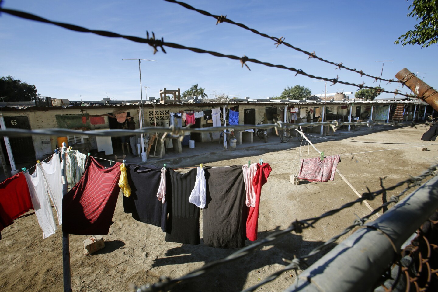 DECEMBER 10, 2013. GUASAVE, SINALOA, MEXICO. At Campo Sacramento in Guasave, Sinaloa, barbed wire runs along the perimeter, and arrivals and departures are controlled around the clock. (Don Bartletti / Los Angeles Times)