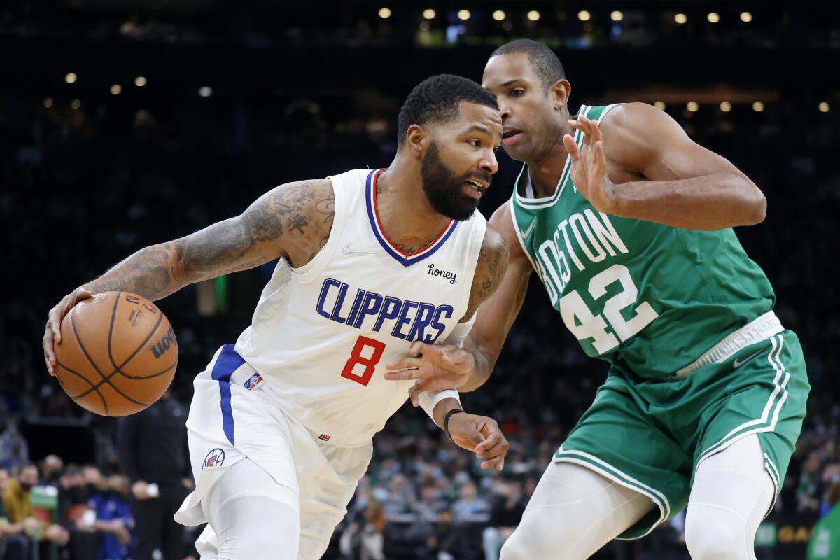 Clippers forward Marcus Morris Sr. drives against Boston Celtics center Al Horford.