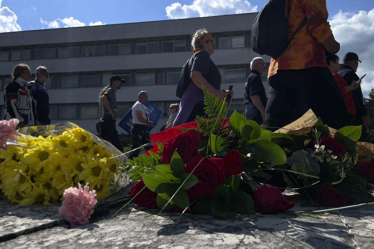 People gather outside the hospital where Slovak Prime Minister Robert Fico is being treated in Banska Bystrica, Slovakia.