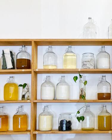Wood shelves hold bottles of liquids and creams at the Well Refill in Topanga.