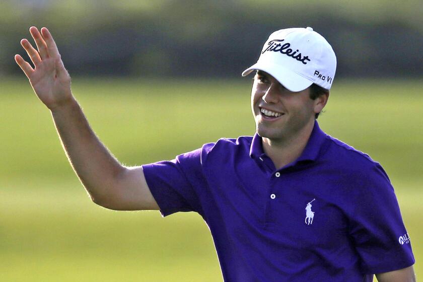 Ben Martin gives a wave to the gallery after a chip-in birdie on the 17th hole during the opening round of the Zurich Classic golf tournament at TPC Louisiana in Avondale.