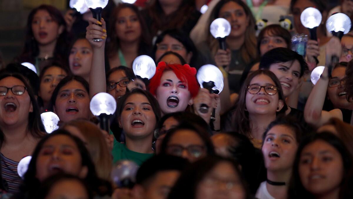Many in the crowd waved Bluetooth-equipped light sticks.