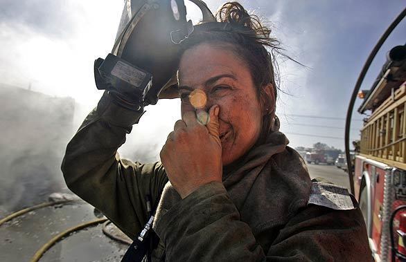 L.A. County firefighter Jenny Teer is covered in soot after fighting a fire at Sky Terrace Mobile Lodge.