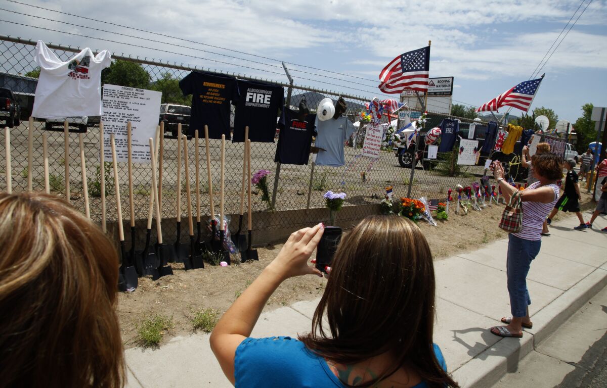 A fence in Prescott, Ariz., has become a public memorial for people to express their grief over the fallen firefighters.