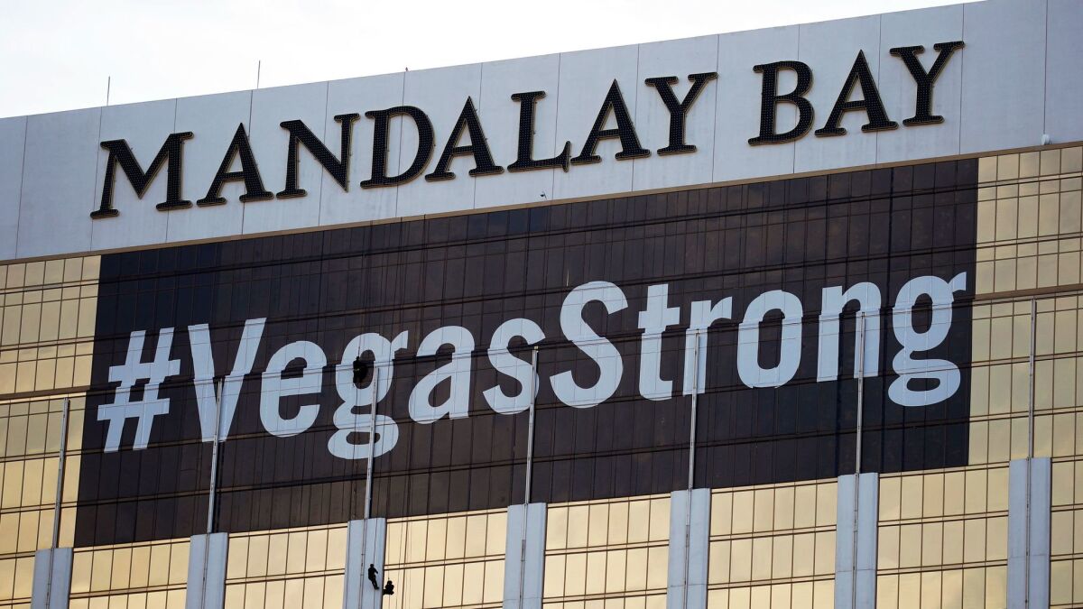 Workers install a #VegasStrong banner on the Mandalay Bay Resort and Casino in Las Vegas. Stephen Paddock opened fire from the hotel on an outdoor country music concert, killing 58 and injuring hundreds.