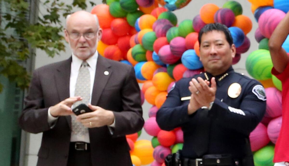 Torrance Police Chief Mark Matsuda, seen at right in 2015 with Torrance Mayor Patrick Furey, has been sued by a police lieutenant alleging retaliation.