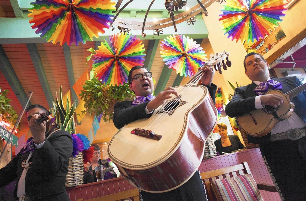 Mariachi performers entertain guests at Avila's El Ranchito restaurant in Costa Mesa in 2016.