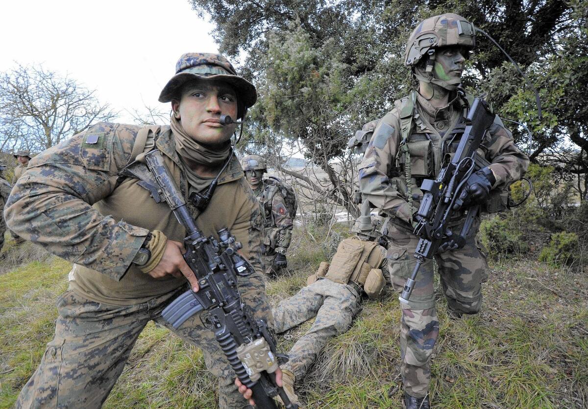 A U.S. Marine, left, in the Special Purpose Marine Air Ground Task Force for Crisis Response, and a French marine take part in a training exercise in southern France. The U.S. force responds to crises in Africa.