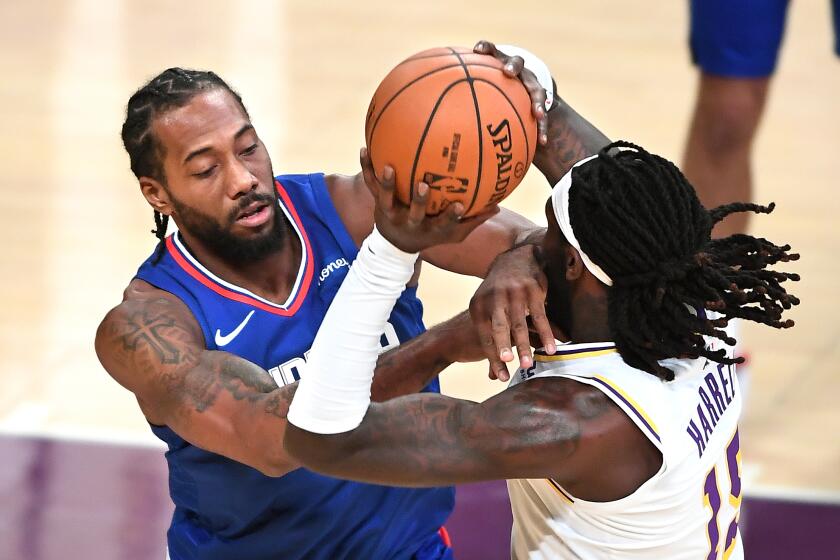 The Clippers' Kawhi Leonard fouls the Lakers' Montrezl Harrell during an exhibition game Dec. 11, 2020.