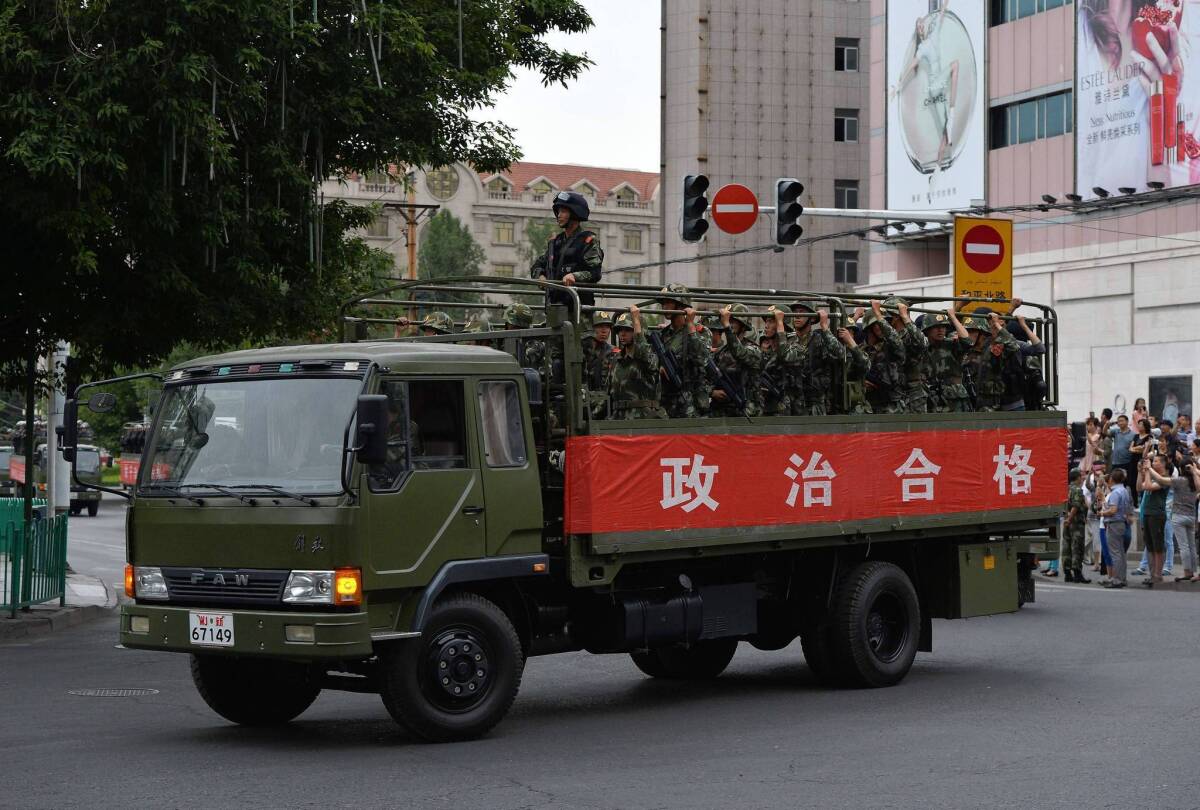 Chinese paramilitary police are trucked in to Urumqi after outbreaks of violence in the far-western province of Xinjiang.