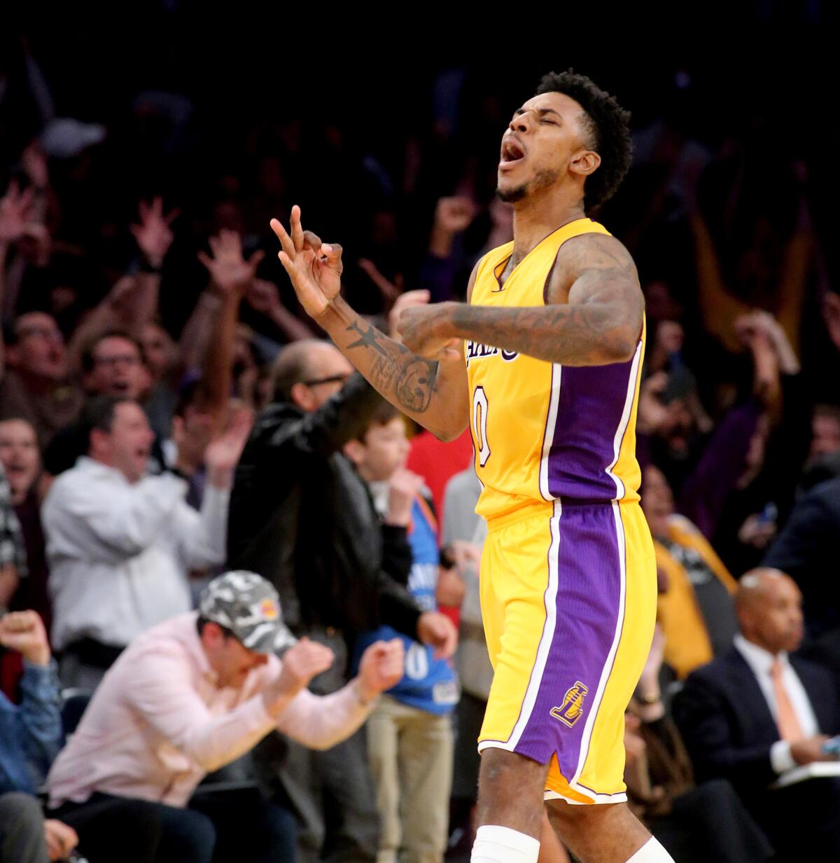 Guard Nick Young celebrates a three-point shot in the final seconds that pushed the Lakers ahead of the Thunder, 111-109, on Tuesday.