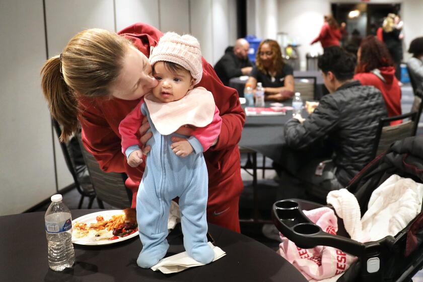 BOULDER-CO-JANUARY 29, 2023: USC women's basketball head coach Lindsay Gottlieb kisses her daughter Reese.