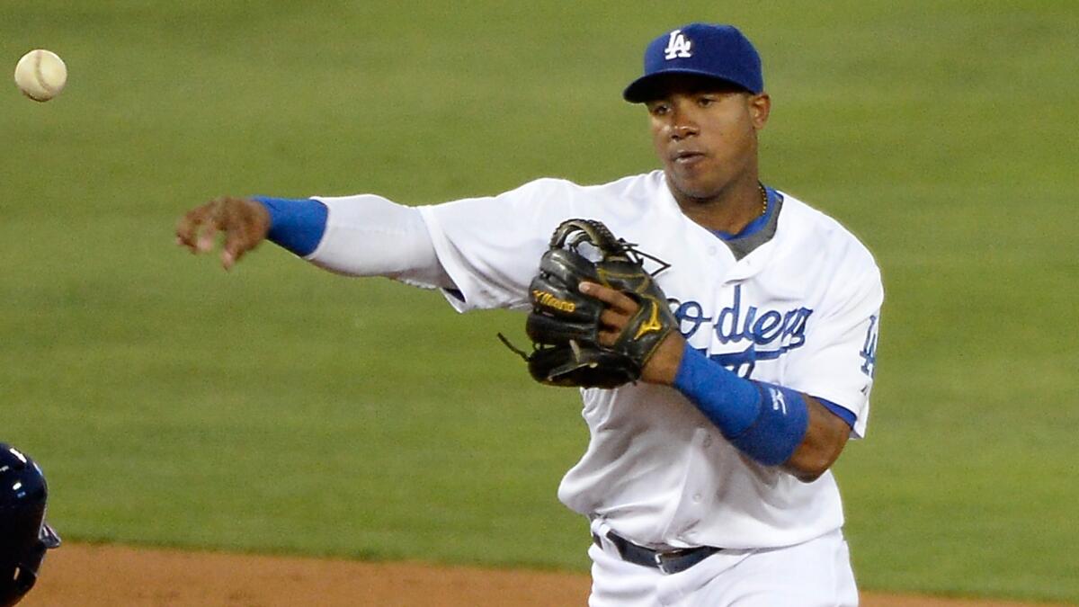 Dodgers shortstop Erisbel Arruebarrena turns a double play against the San Diego Padres on Wednesday. Arruebarrena has been sent down to class-A Rancho Cucamonga to make room for Hanley Ramirez on the active roster.