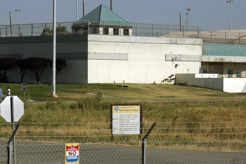 FILE - The Federal Correctional Institution is shown in Dublin, Calif., July 20, 2006. Nearly 100 federal Bureau of Prisons employees have been arrested, convicted or sentenced in criminal cases since the start of 2019, accused of crimes from smuggling drugs and weapons to stealing prison property, sexually assaulting inmates and murder. Those arrested include Ray Garcia, the warden at the Federal Correctional Institution at Dublin. (AP Photo/Ben Margot, File)