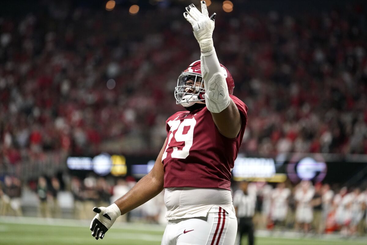 Alabama offensive lineman Chris Owens (79) celebrates a touchdown against Georgia during the first half of the Southeastern Conference championship NCAA college football game, Saturday, Dec. 4, 2021, in Atlanta. (AP Photo/Brynn Anderson)