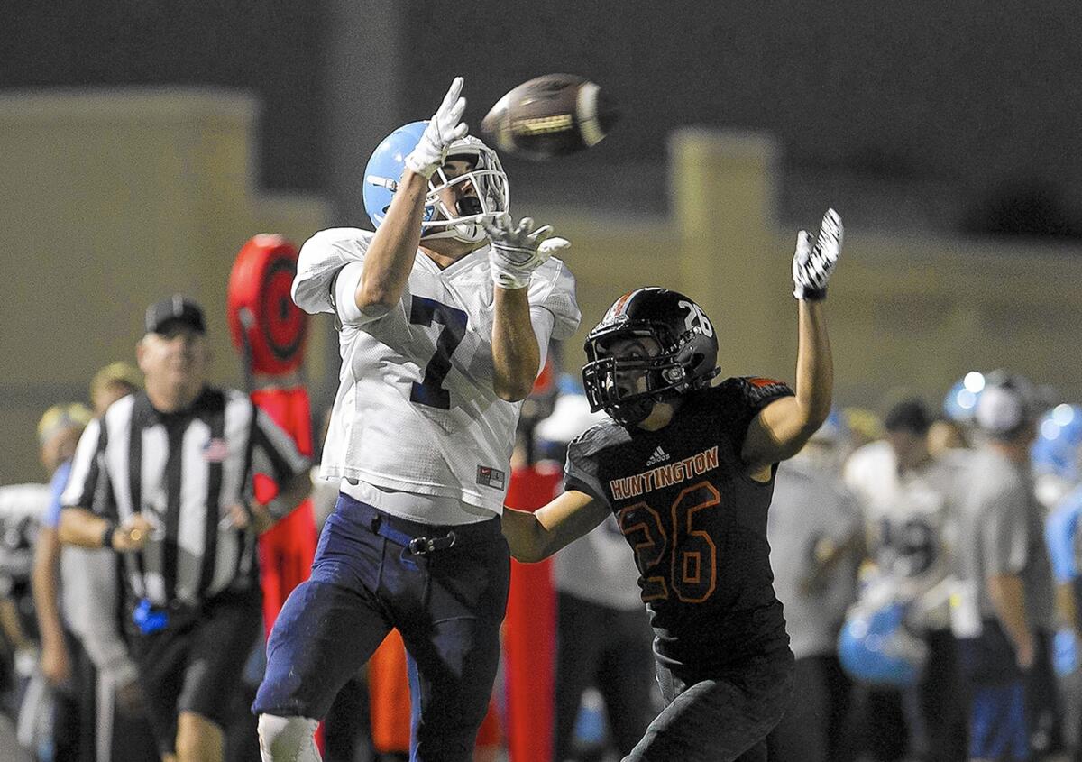 Corona del Mar High's Billy Shaw catches a touchdown pass against Huntington Beach's Jorge Collin during a scrimmage on Friday.