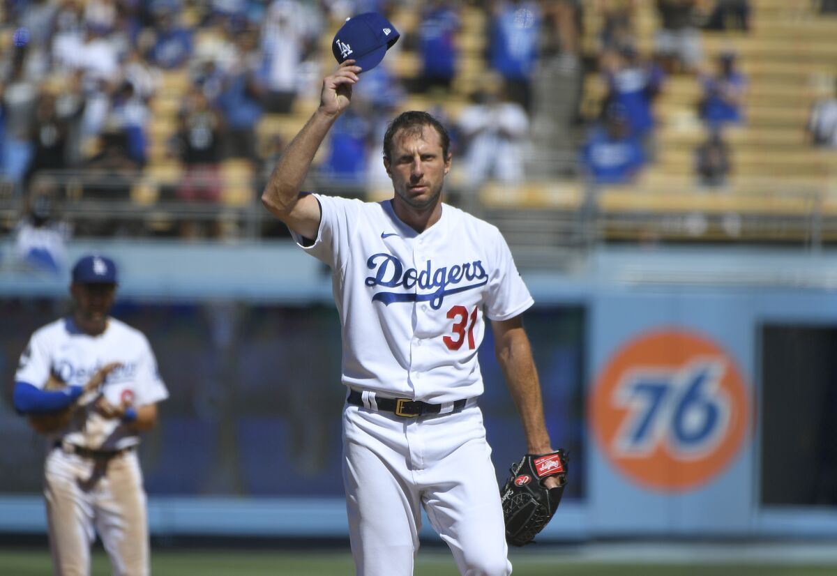 Max Scherzer tips his cap as the crowd at Dodger Stadium gives him a standing ovation 