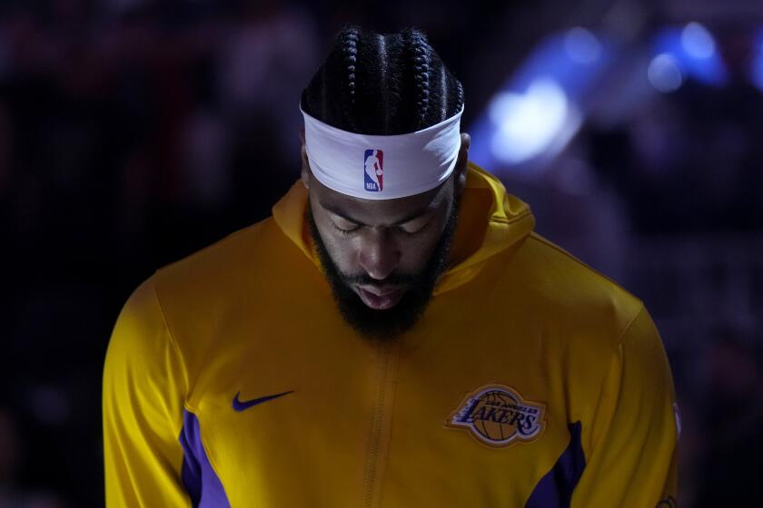 Los Angeles Lakers forward Anthony Davis during the national anthem before an NBA preseason basketball game against the Golden State Warriors in San Francisco, Saturday, Oct. 7, 2023. (AP Photo/Jeff Chiu)