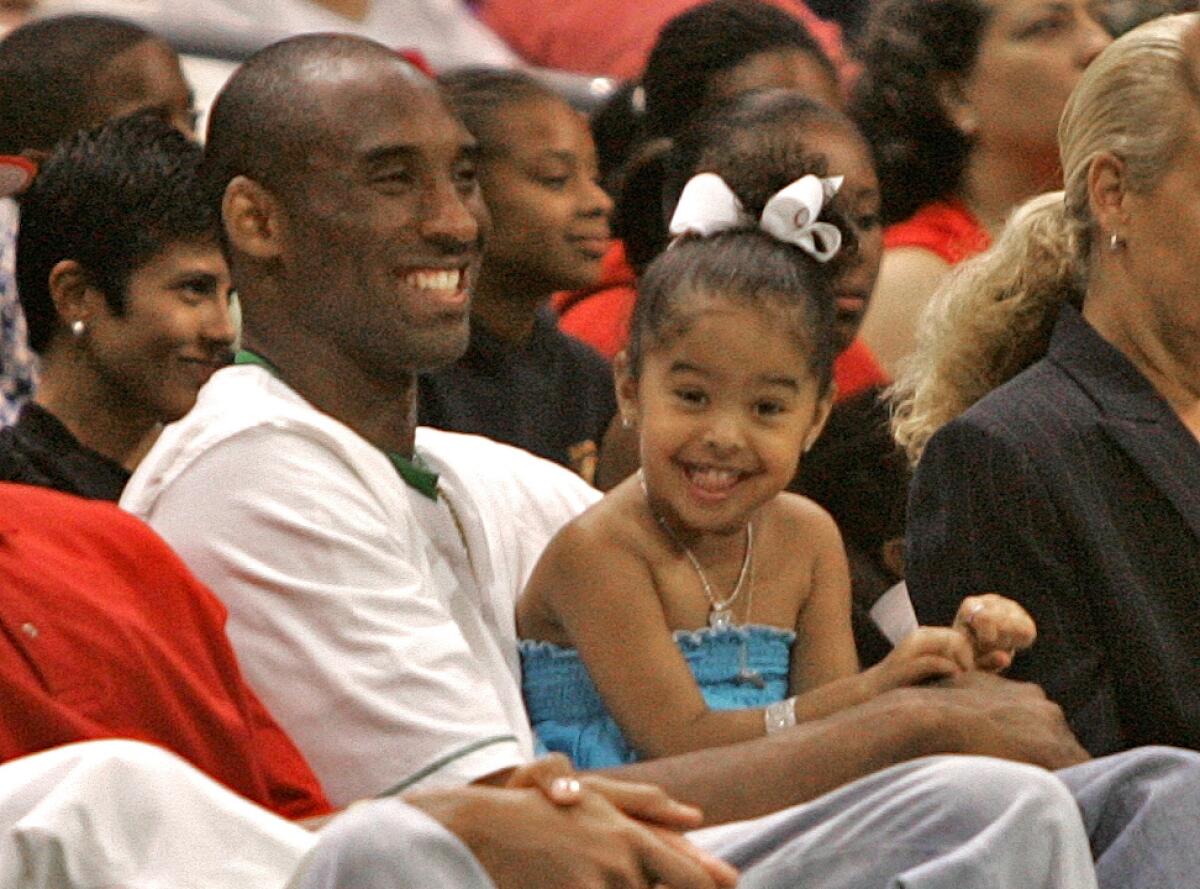 Kobe Bryant and his oldest daughter, Natalia, attend a game between the Sparks and Connecticut Sun at Staples Center in June 2006. Bryant's father, Joe Bryant, was the coach of the Sparks from 2005 until 2007.