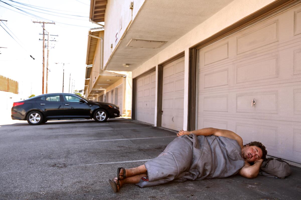 Andrew Truelove sleeping in a parking lot in Torrance in July 2023.
