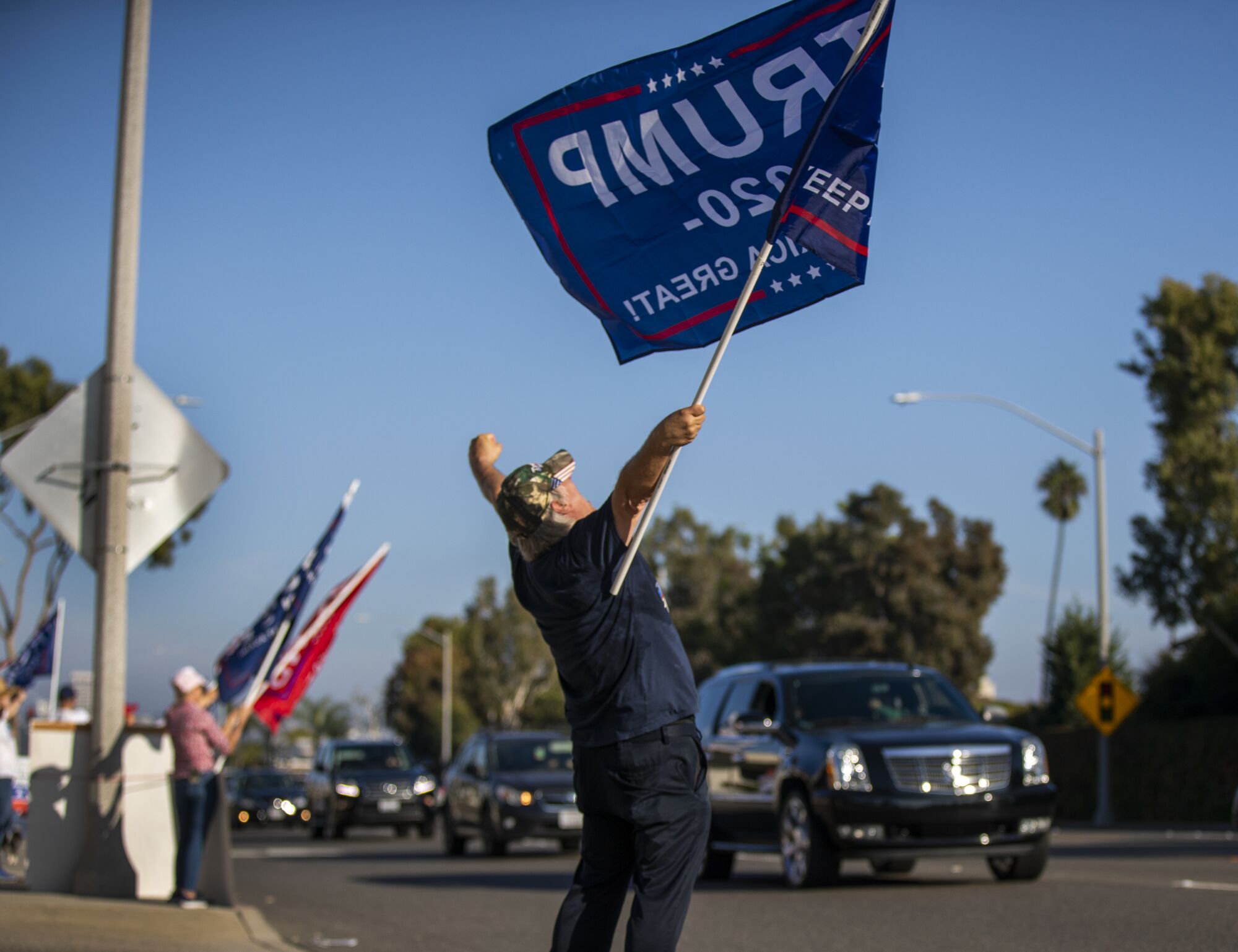 Trump supporter Steve Martin of Westminster dances and cheers on passing motorists.