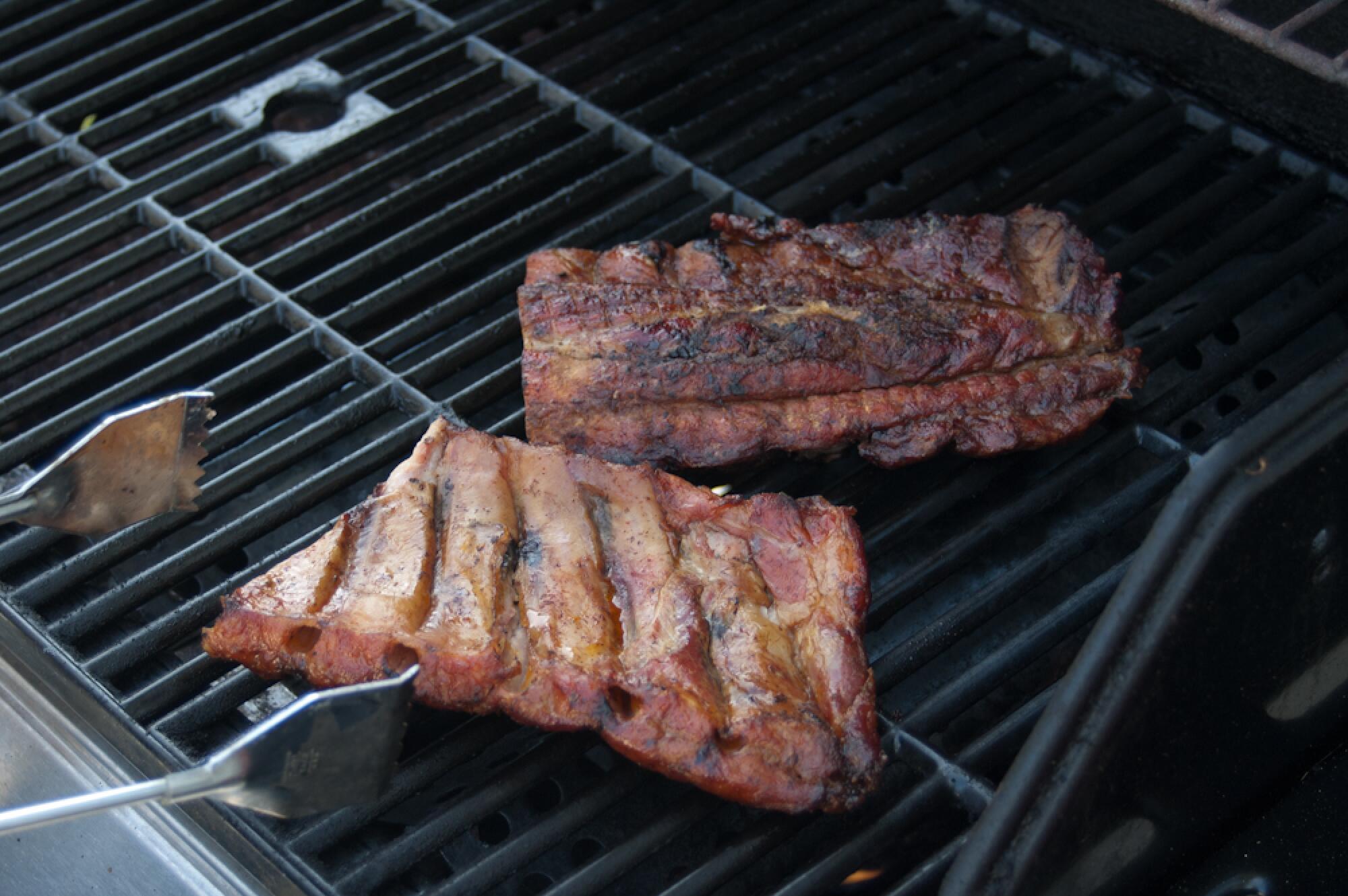 Two slabs of ribs on a grill